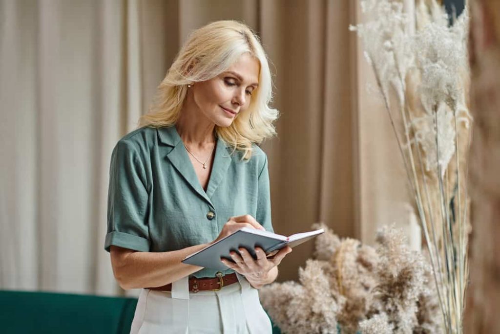A mature woman taking notes about setting goals that stick